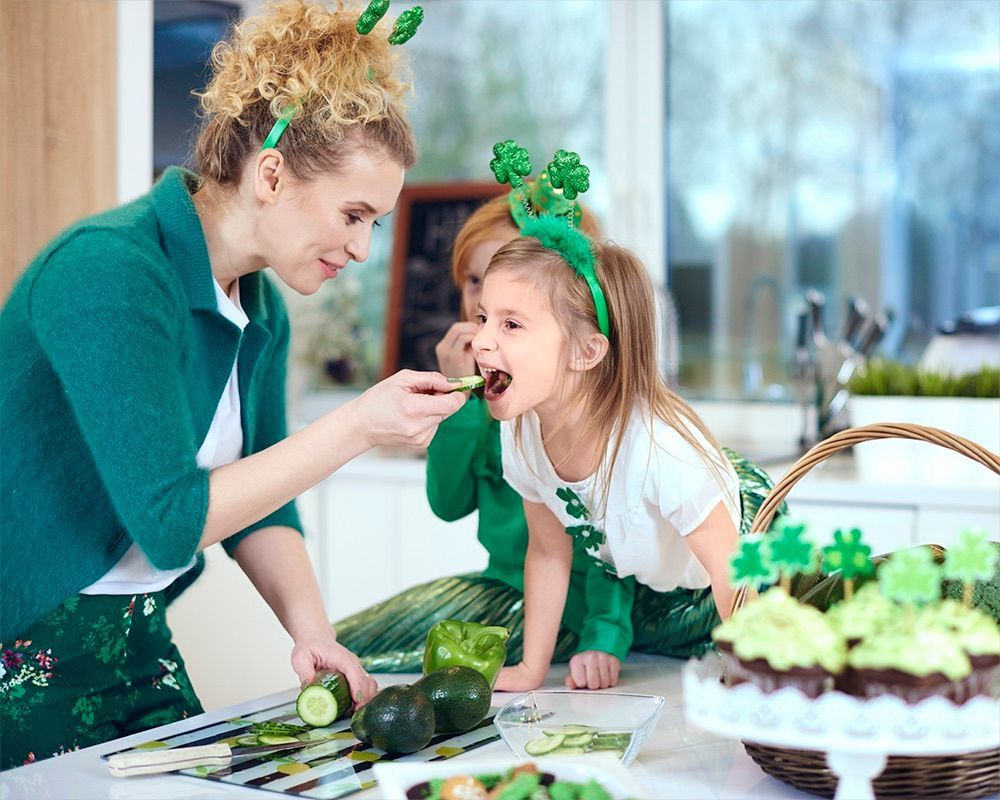 Mother with daughter cooking at kitchen